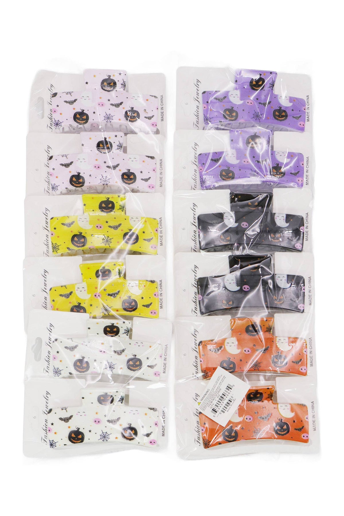 Twelve Halloween Hair Claw clips by Cap Zone arranged in two columns, featuring Halloween-themed patterns like jack-o-lanterns, ghosts, and bats in various colors.