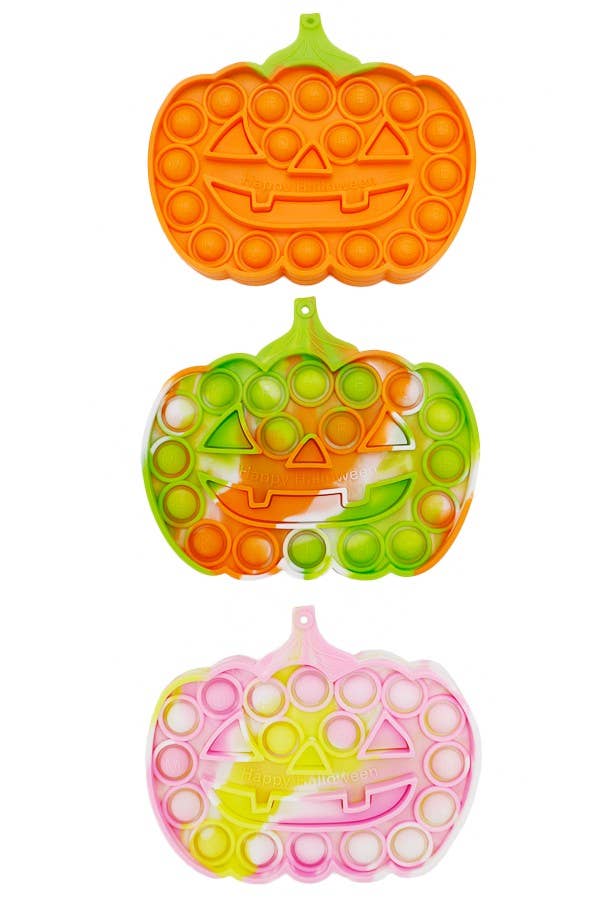 Three Halloween Pumpkin Sensory Toy silicone pop-its in orange, multi-colored tie-dye, and pink tie-dye, each with Happy Halloween embossed on the front.