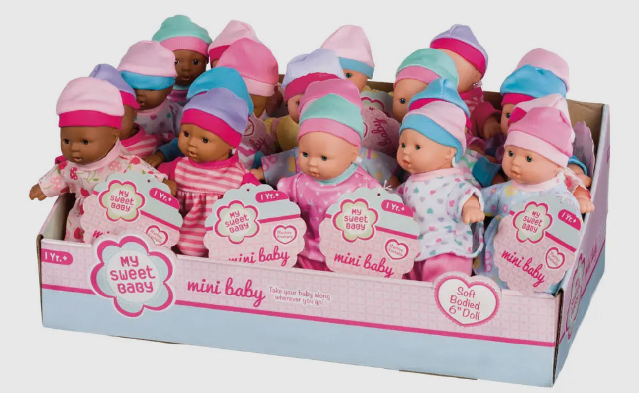 The Toy Smith My Sweet Baby Mini Babies are soft-bodied dolls in assorted skin tones, each dressed in colorful pink, blue, or purple outfits and hats. Arrives in a cardboard display box.