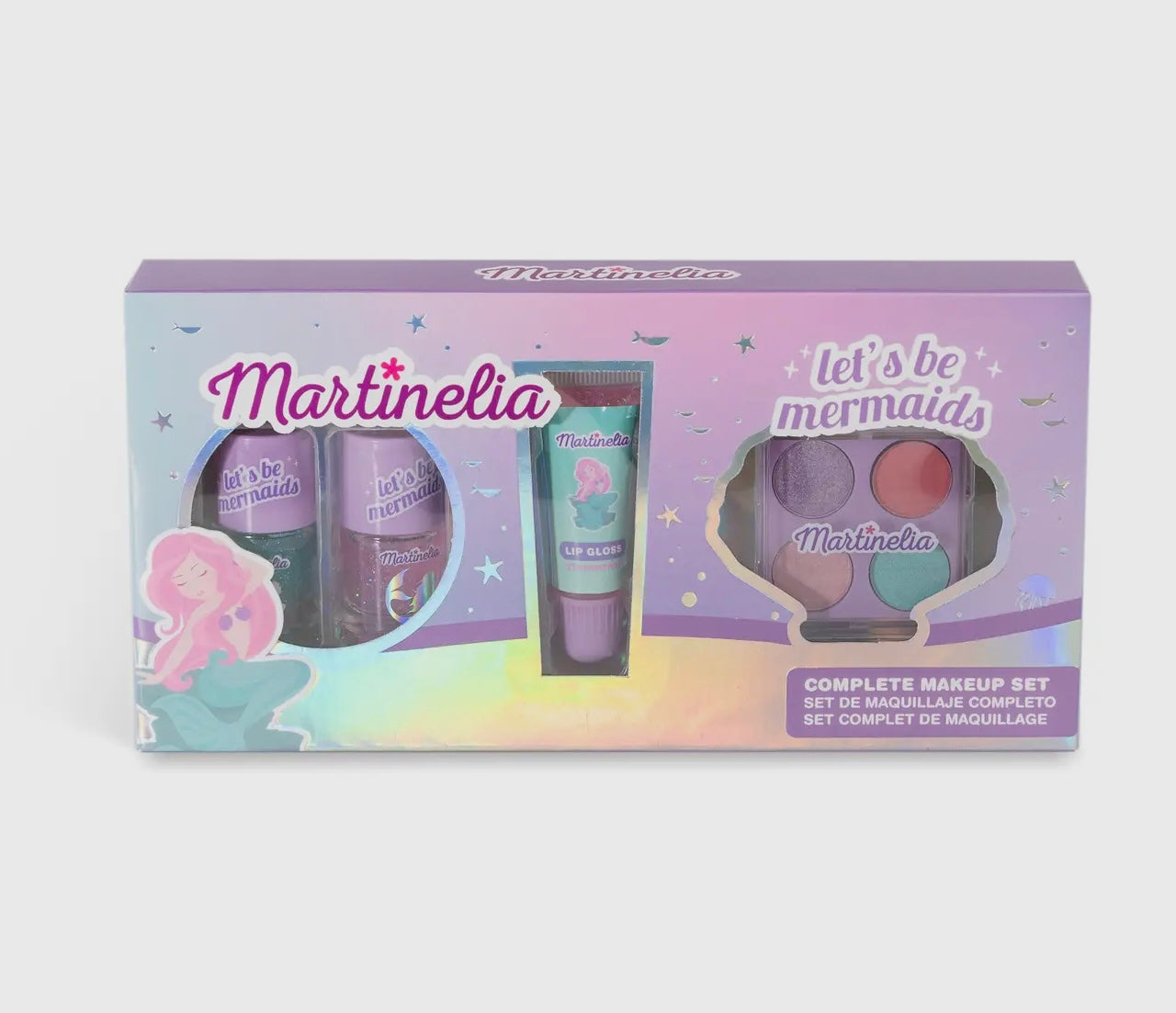 The Toy Smith Let's Be Mermaids Complete Makeup Set comes in a shiny pastel box with mermaid-themed graphics and includes lip gloss, nail polish, and an eyeshadow palette plus a cute cartoon mermaid illustration.