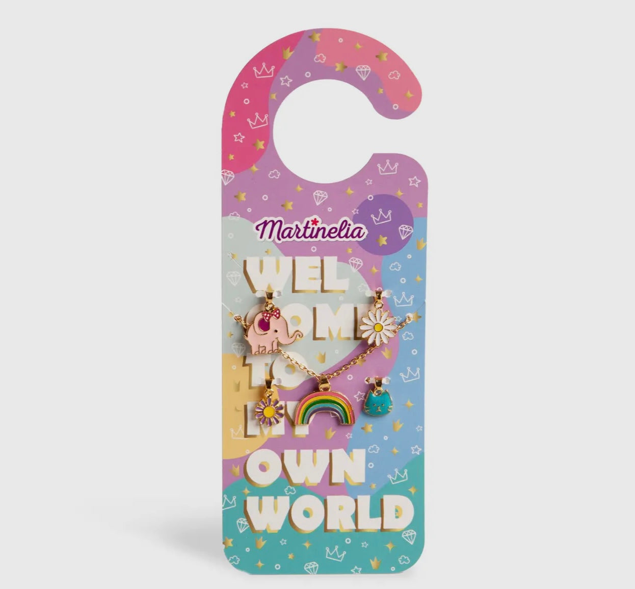 The Toy Smith Door Hanger Necklace Set features a colorful door hanger reading "Martinelia Welcome To Own World," decorated with hearts, stars, and crowns, plus three playful charm bracelets with unicorn, rainbow, and sun designs.
