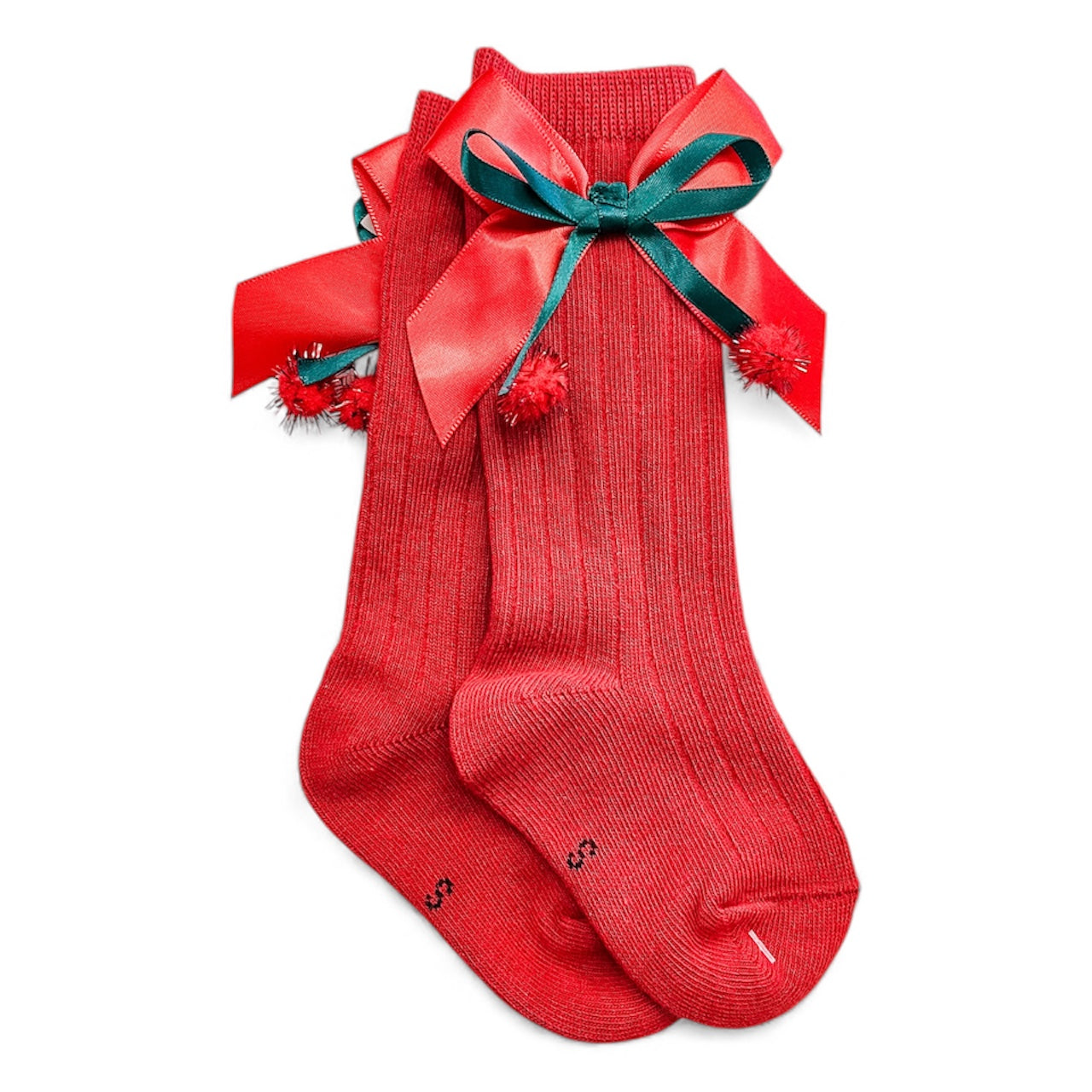 Merry Toes Socks by Tiny Tot Bundles are red ribbed socks adorned with large red and green ribbon bows and small red pom-poms, shown on a white background.