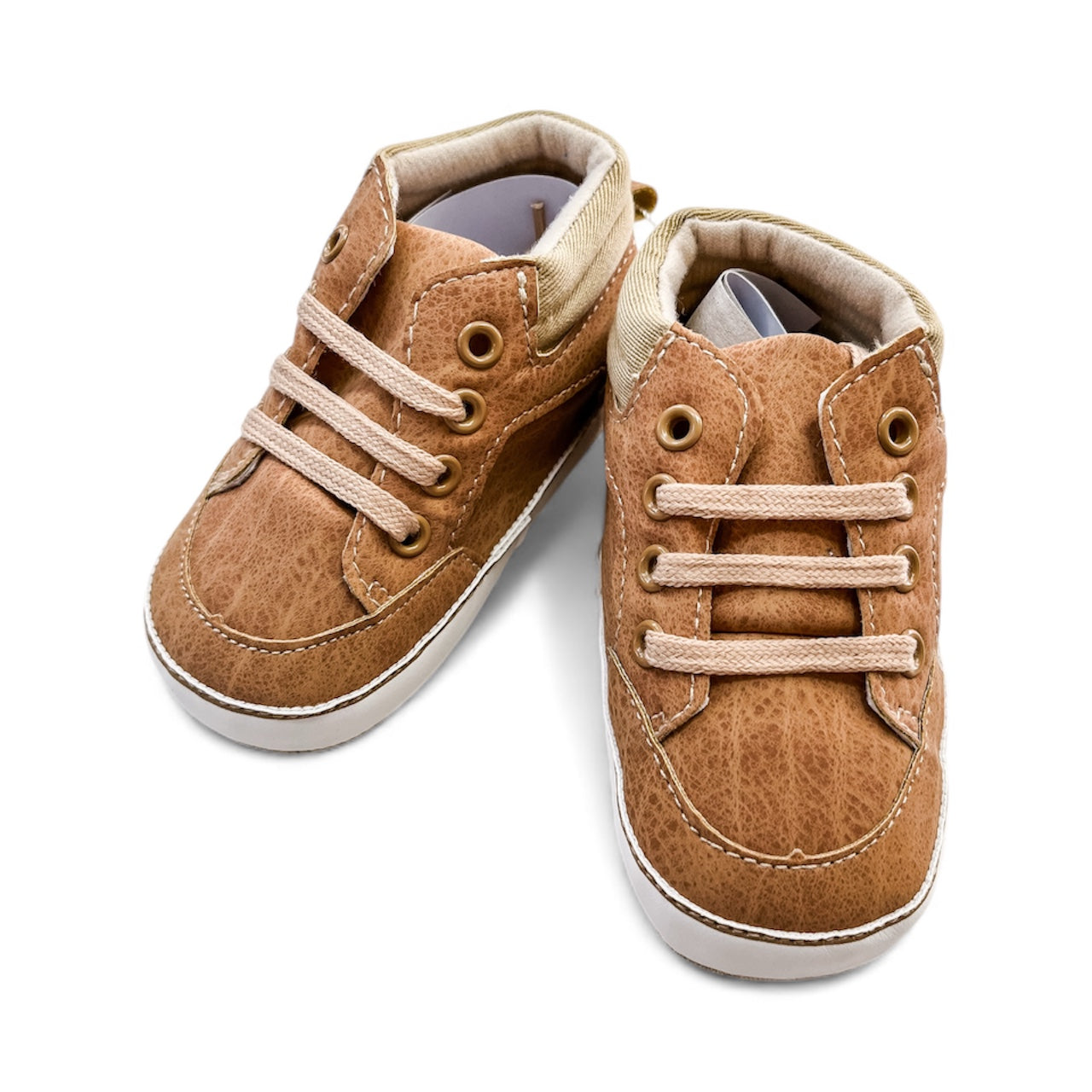 The Tiny Tot Bundles Mini Explorer High Tops are small brown baby shoes with beige laces and white soles, shown side by side on a white background.