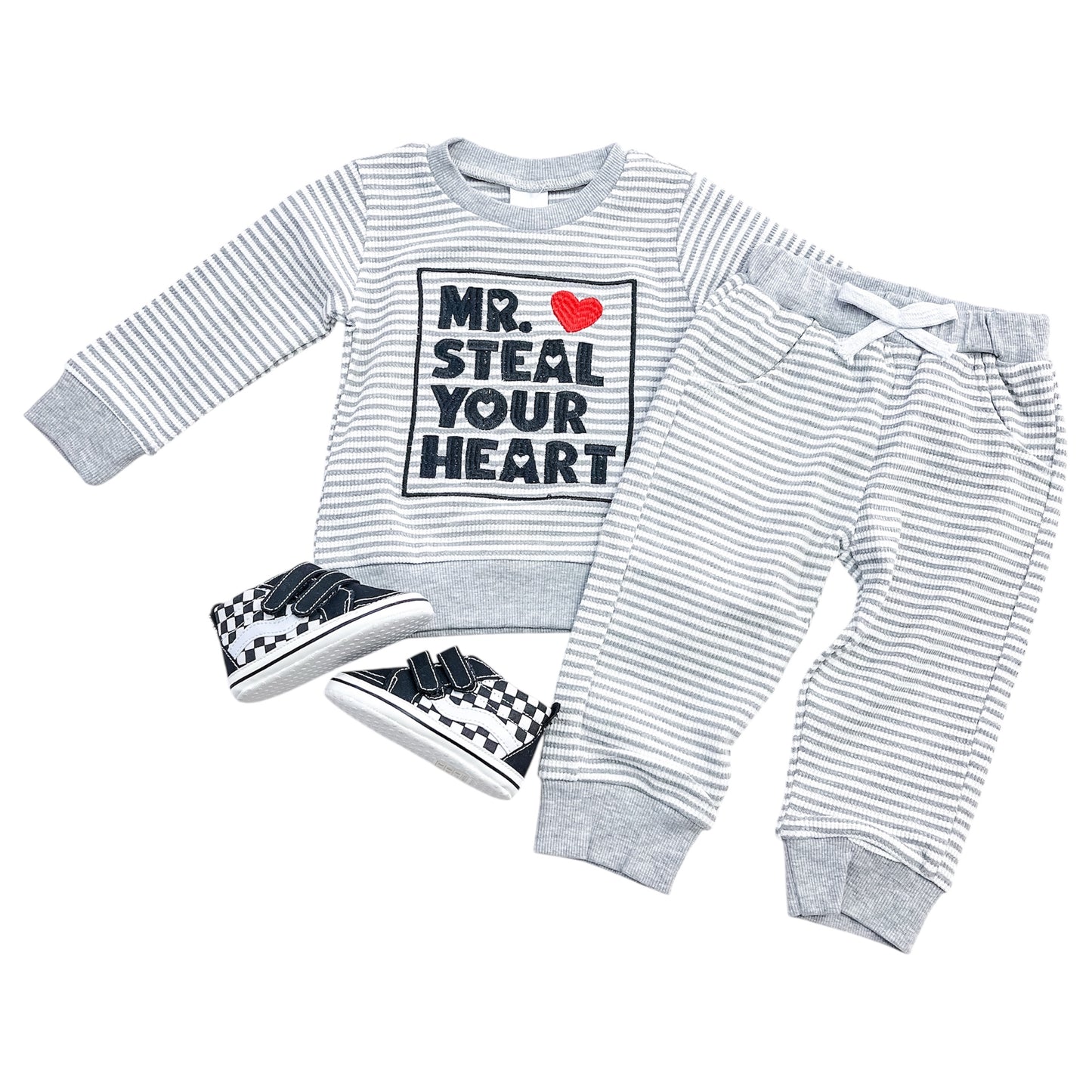 The Little Hearts Stealer Set by Tiny Tot Bundles includes a gray and white striped long-sleeve shirt with "Mr. Steal Your Heart" and red heart graphic, matching drawstring pants, and black-and-white checkered sneakers.