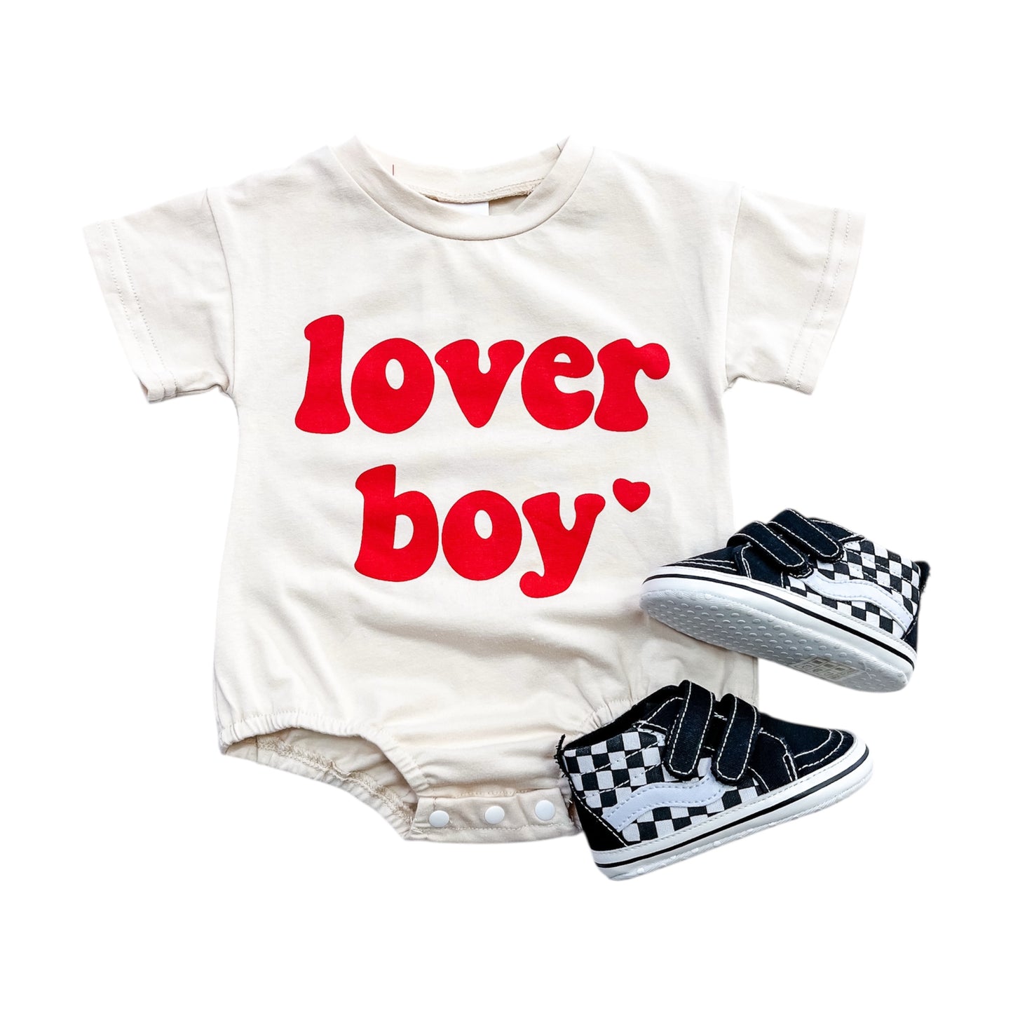 The Beige Lover Boy Bubble by Tiny Tot Bundles features bold red "lover boy" lettering, paired with black and white checkered baby sneakers, displayed on a white background.