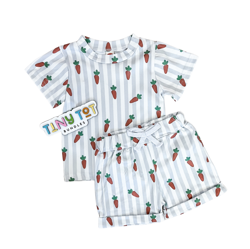 The Stripe Carrot Shorts Set by Tiny Tot Bundles features a short-sleeved shirt and matching shorts with white and pale gray vertical stripes, a carrot print, and a colorful Tiny Tot Bundles tag beside the outfit.
