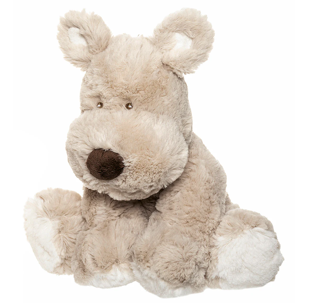 The Triaction Teddy Dog Plush is a soft, light beige plush toy with a large round brown nose, floppy ears, and fluffy white paws. It sits upright against a plain white background.