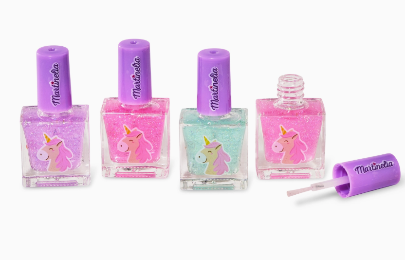 The Toy Smith Little Unicorn Nail Polish Set includes four bottles—purple, pink, teal, and light pink—with glittery unicorn designs and purple lids; one bottle is open with the brush in front.