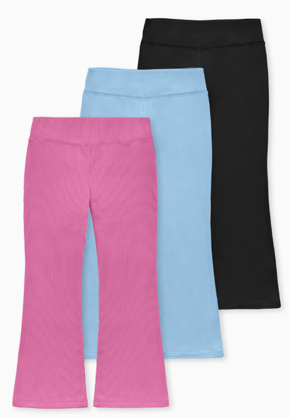 Three pairs of Tiny Tot Bundles’ Everyday Comfort Flare Leggings are shown overlapping—a pink ribbed pair with flared legs in front, a light blue pair in the middle, and a plain black pair at the back—laid flat on a white background.
