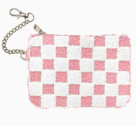 The Living Royal Checkered Cutie Coin Pouch is a small rectangular pouch with a pink and white checkerboard pattern, zipper closure, and a silver chain clasp on one corner.
