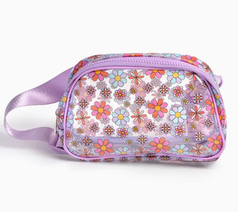 The Living Royal Retro Daisy Belt Bag is a small, rectangular bag with a light purple strap and zipper, featuring colorful pink, orange, blue, and white daisy patterns on a transparent surface.