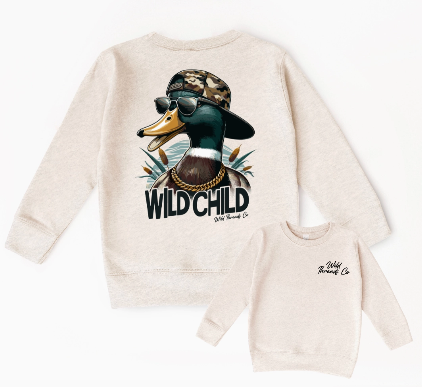 Two beige Wild Threads Co sweatshirts: the larger features the Wild Child Duck with sunglasses, camo hat, and gold chain; the smaller has a small Wild Threads Co logo on the chest.