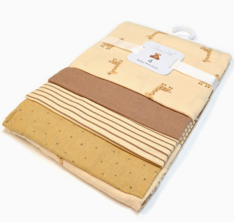 The Lollipop Dreams Gentle Giraffe Blanket Set includes four neatly folded baby blankets—giraffe print, solid brown, brown stripes, and tan with dots—tied with a white ribbon and labeled as a 4-pack.