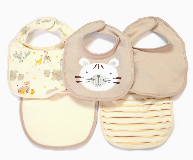 The Little Tiger Bib Set by Lollipop Dreams includes five neutral-toned baby bibs with animal designs, a tiger face, solid beige, plain cream, and beige stripes. All feature rounded edges and neck fasteners.