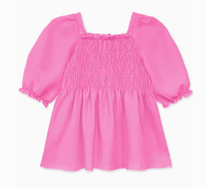 The Sugarplum Smocked Blouse by Cutie Patootie features a bright pink hue, puffed short sleeves, a square neckline, and a smocked bodice. Crafted from lightweight fabric, it offers a loose, flowy fit for effortless style.