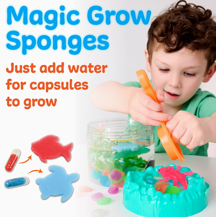 A young child uses tweezers to play with colorful axolotl sponge shapes and capsules in water. Text reads: Sensory Adventure Bucket: Water Play Axolotls by Creativity For Kids. Just add water for capsules to grow into axolotls.