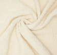 Close-up of the crover 100% Cotton Waffle Baby Blanket in Almond, featuring soft, cream-colored textured fabric with a cozy, plush surface and gentle twist at the center.