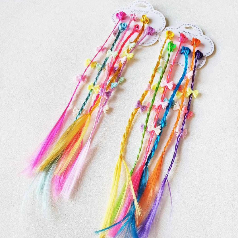 The funteze Rainbow Fairy Braid Clip Set features two sets of colorful hair extensions with beads and butterfly clips in vibrant shades of pink, purple, yellow, green, and blue, displayed on white cards against a white background.