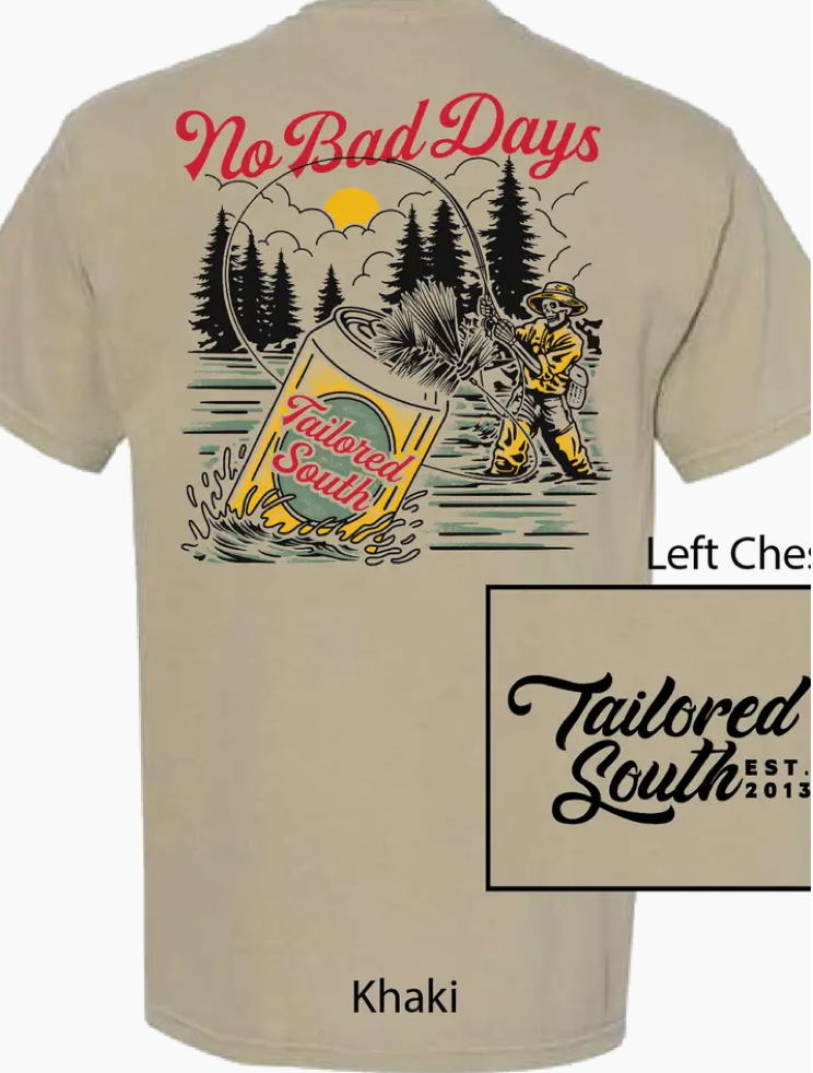 The No Bad Days Khaki Men T-Shirt by Wild Trail Outfitters features a large back graphic of a man fishing with a Tailored South can on his line, trees and sun behind, “No Bad Days” text above, and the Tailored South logo on the left chest.