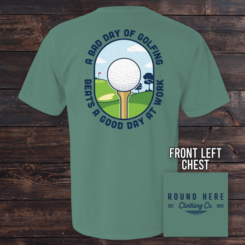 The Old North State's Good Day Golf Men's Tee is green, with a large back graphic of a golf tee and ball on a fairway, reading "A BAD DAY OF GOLFING BEATS A GOOD DAY AT WORK," and the Round Here Clothing Co. logo on the front chest.
