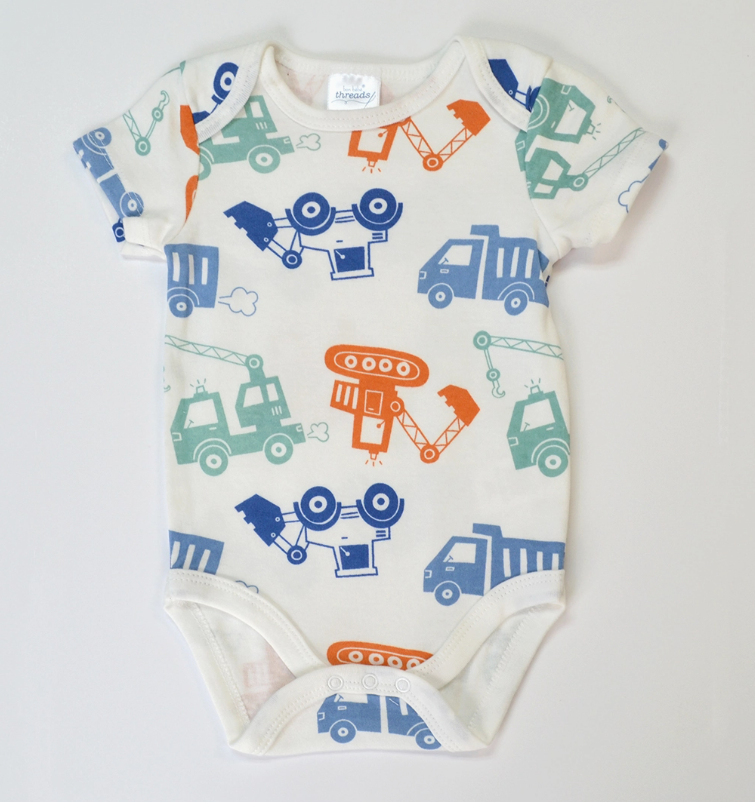 The Lollipop Dreams Tiny Crew Bubble Trio is a short sleeve baby onesie with a white background and colorful construction vehicles—dump trucks, cranes, and cement mixers—in blue, green, and orange.