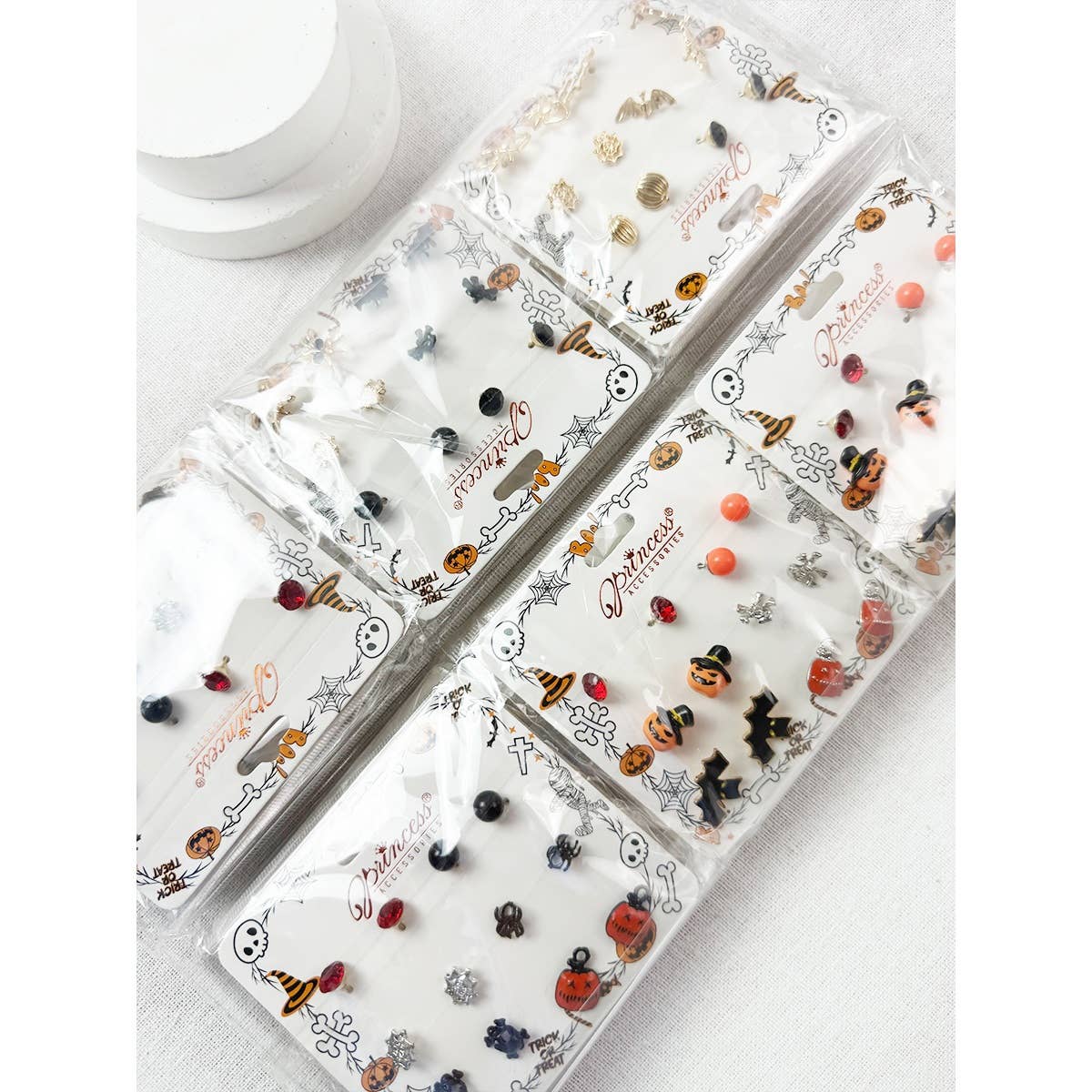 Five sets of Cute Halloween Theme Earring Set studs, featuring designs such as pumpkins, witches hats, ghosts, bats, and spiders, displayed on white cardboard backing cards.