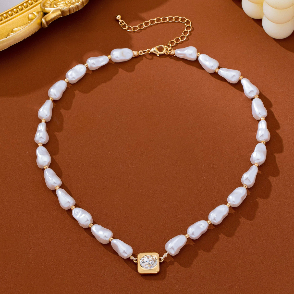JOSSLYN by wall to wall Baroque Pearl & Bezel-Set Crystal Necklace featuring irregular white pearls, gold beads, and a single square bezel-set crystal pendant.