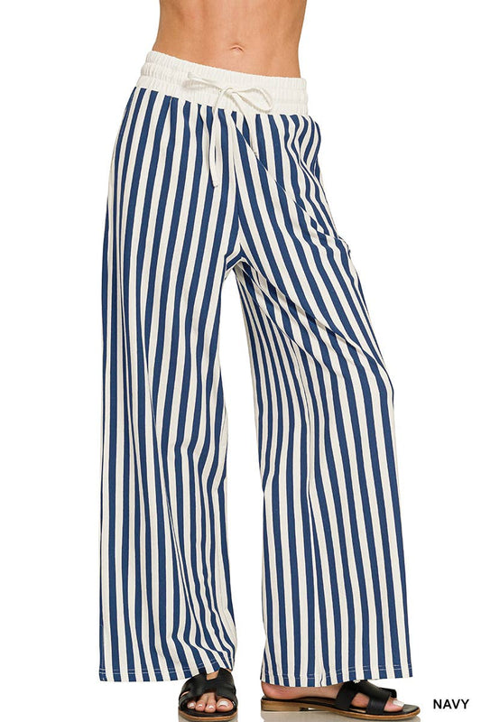 Vertical Striped Wide Leg Pants w/ Pockets in navy and white vertical stripes, featuring an elasticized drawstring waist.