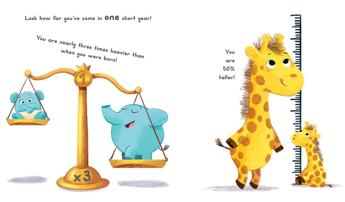 An illustration from Simon & Schuster's "Now You Are 1 Book" shows a scale with an elephant three times heavier than a bear cub. Nearby, a tall giraffe stands by a ruler, while a smaller giraffe marks its 50% growth.