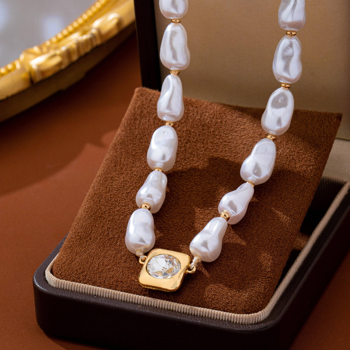 JOSSLYN by wall to wall Baroque Pearl & Bezel-Set Crystal Necklace featuring baroque pearls with gold spacers and a square, bezel-set crystal pendant.