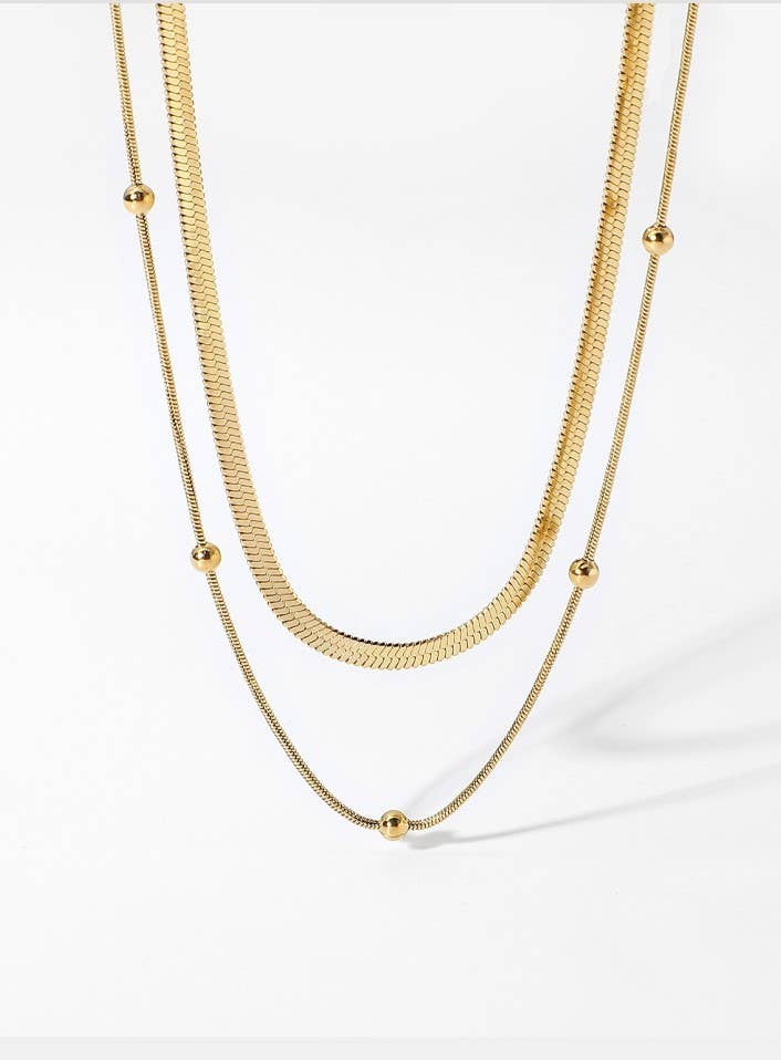 JOSSLYN by wall to wall Dainty Layered Tarnish Free Necklace featuring a gold flat herringbone chain and a delicate chain with small round beads.