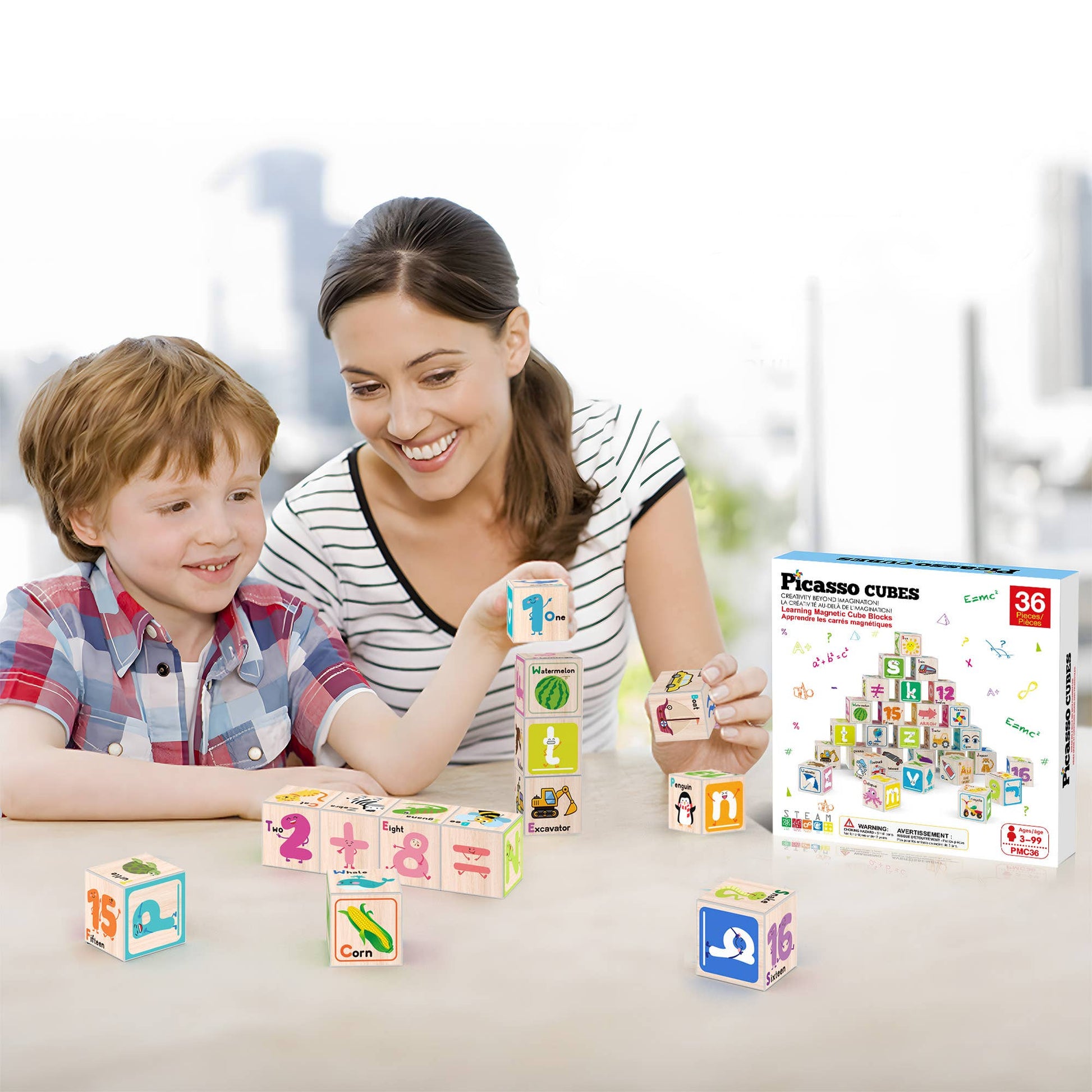 A smiling woman and child play with vibrant magnetic blocks from the PicassoTiles 36pc 1" Magnetic Cubes Set at a table. The PicassoTiles box is visible nearby, with a bright, modern city scene in the background.