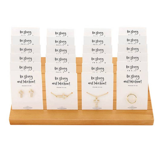 Faithworks by Creative Brands Mother of Pearl Cross Filled Display features gold-colored cross necklaces and rings arranged in rows on a wooden stand, each presented on a card that reads “Be Strong and Take Heart.”.