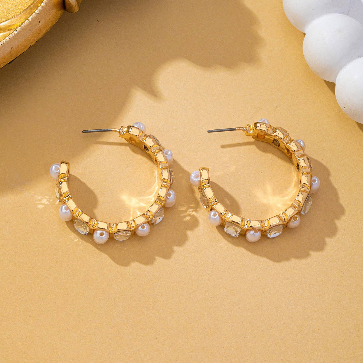 JOSSLYN by wall to wall Pearl & Rhinestone Hoop Earrings featuring two gold hoops embellished with alternating round white pearls and clear gemstones.