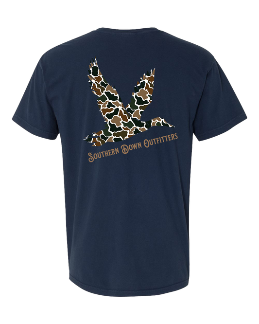The Camo Mallard Toddler Tee by Southern Down Outfitters is a navy blue t-shirt featuring a camo-patterned duck foot graphic and the brand name printed on the back.