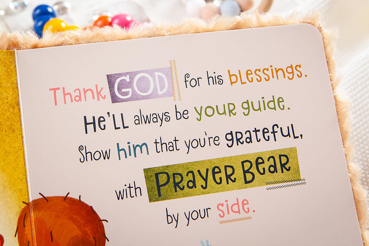 A children’s book page from the Prayer Bear Book by *BroadStreet Publishing Group, LLC* reads: Thank GOD for his blessings. He’ll always be your guide. Show him that you’re grateful, with PRAYER BEAR by your side. Colorful letters and fuzzy edges are visible.