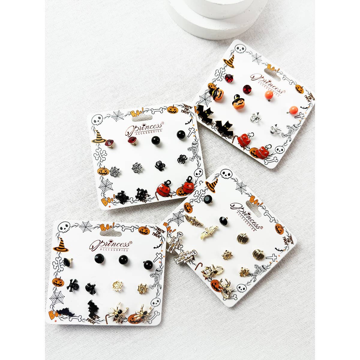 Cute Halloween Theme Earring Set featuring four sets of stud earrings on individual cards with icons of pumpkins, ghosts, bats, spiders, and witches hats.