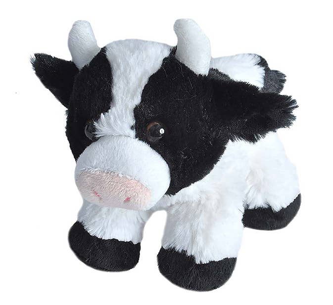 The Wild Republic Mini Cow Stuffed Animal features black and white fur, small horns, a pink snout, and black hooves, standing on all four legs against a white background.