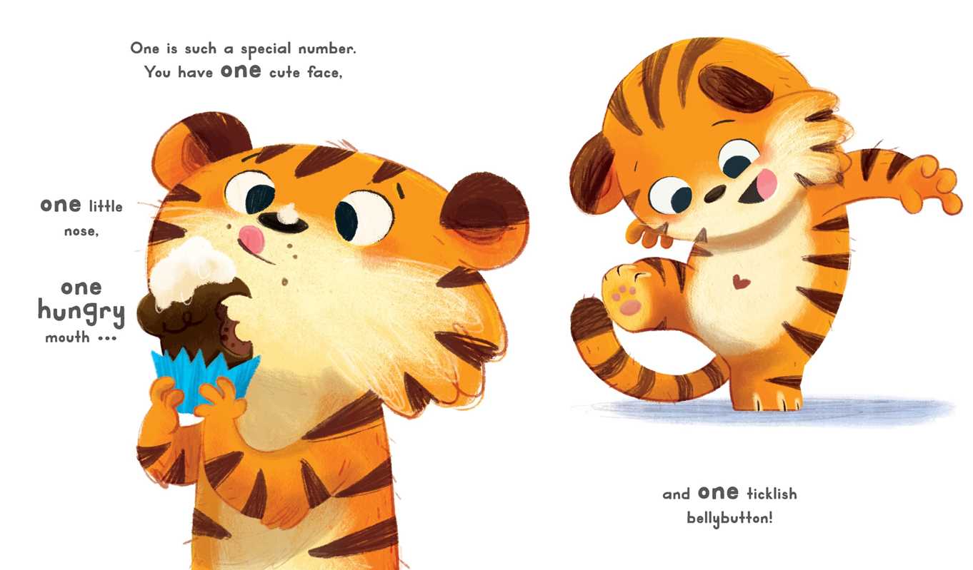 On the Now You Are 1 Book by Simon & Schuster, an illustrated tiger cub licks its lips beside text about its cute face, then playfully lifts its leg to reveal its belly and a happy expression.
