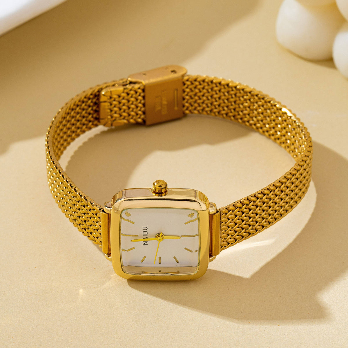 JOSSLYN by wall to wall Square Mesh Band Bracelet Watch featuring a gold-tone square case, a matching mesh band, and a white face.