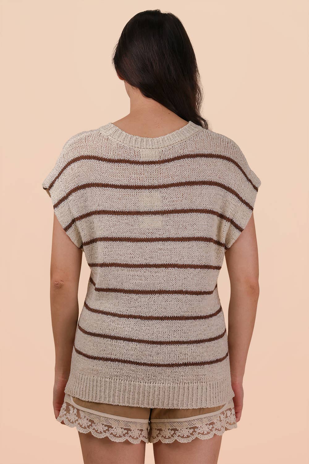 Back view of a person wearing a beige VERY J Striped Knit Sweater Vest Top with brown horizontal stripes.