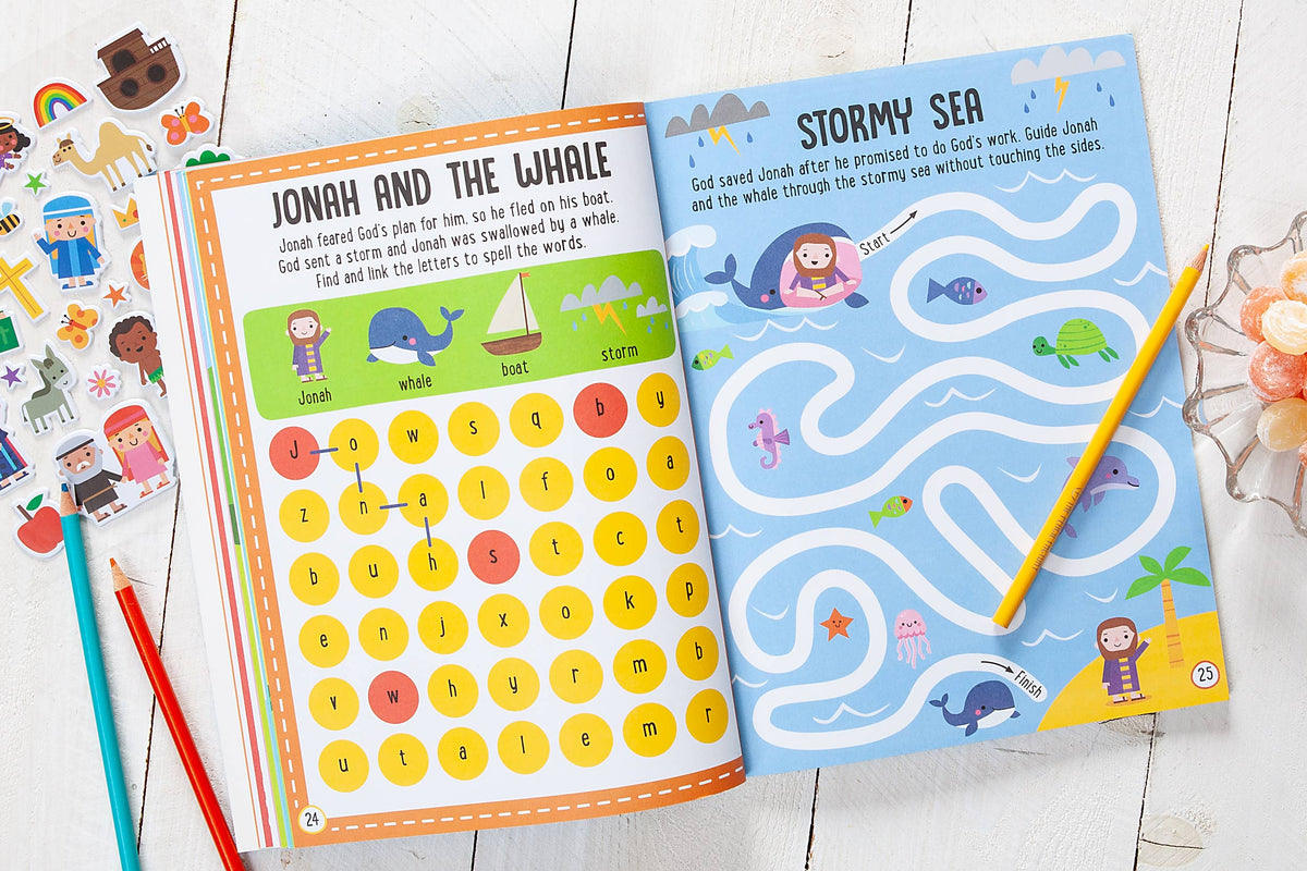 Two open pages of the My Bible Stories Activity Book by BroadStreet Publishing Group, LLC: one features a Jonah and the Whale word search, the other shows a Stormy Sea maze—both filled with colorful illustrations and playful characters, with pencils and stickers scattered on a white table.