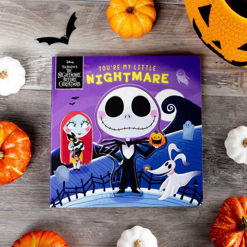 You’re My Little Nightmare by Grace Baranowski, a children’s book from Simon & Schuster, features charming cartoon characters inspired by Jack Skellington and Sally from The Nightmare Before Christmas, shown surrounded by pumpkins on a wooden surface.