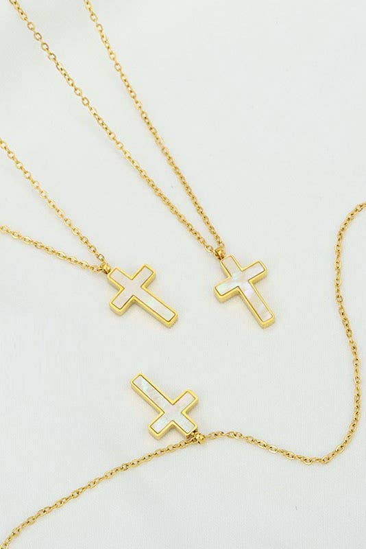 Three Tarnish Free Cross Necklaces by JOSSLYN by wall to wall, each featuring a simple outlined design and delicate chain, are displayed on a white surface. Two crosses are upright while one is tilted to the side.