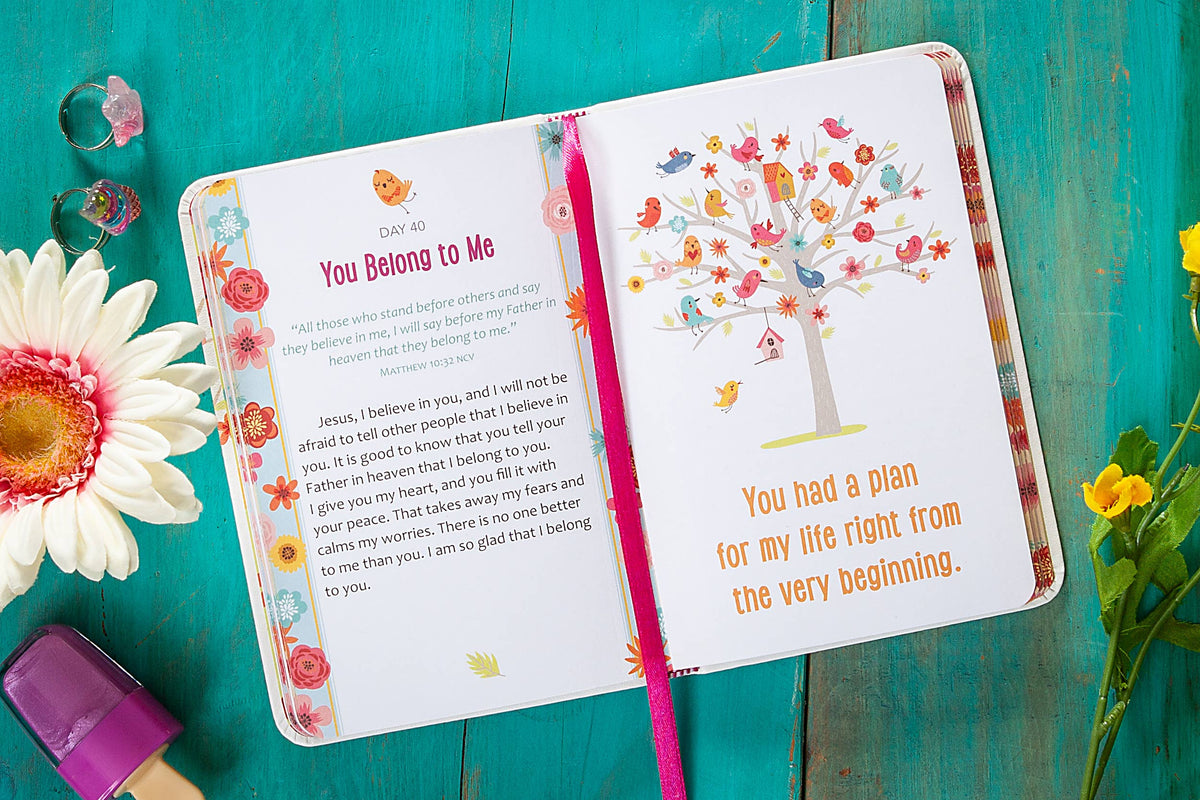 A 2-Minute Prayers for Girls Book by BroadStreet Publishing Group, LLC lies open, revealing a devotion on the left page and an illustration of a tree with colorful birds alongside the words “You had a plan for my life right from the very beginning” on the right page, surrounded by flowers and stationery.