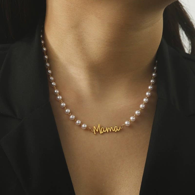 A woman wears the JOSSLYN by wall to wall Pearl Mama Necklace, styled with a black blazer.