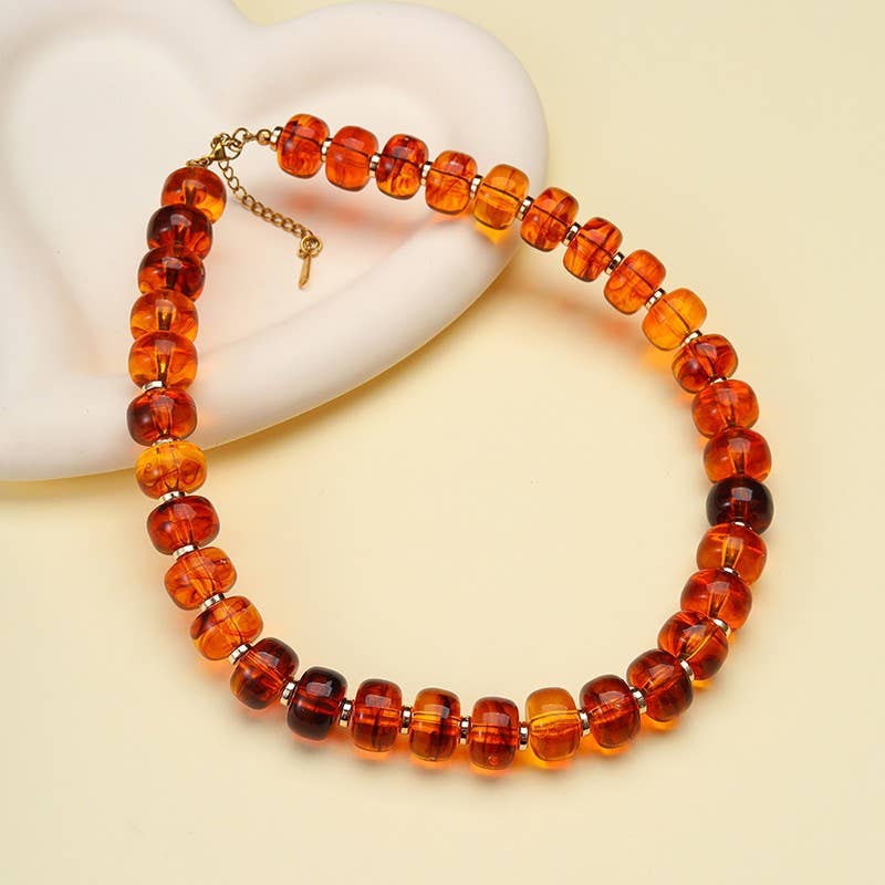 JOSSLYN by wall to wall Chunky Amber-Tone Barrel Bead Necklace featuring translucent, amber-toned barrel beads with gold-tone hardware.
