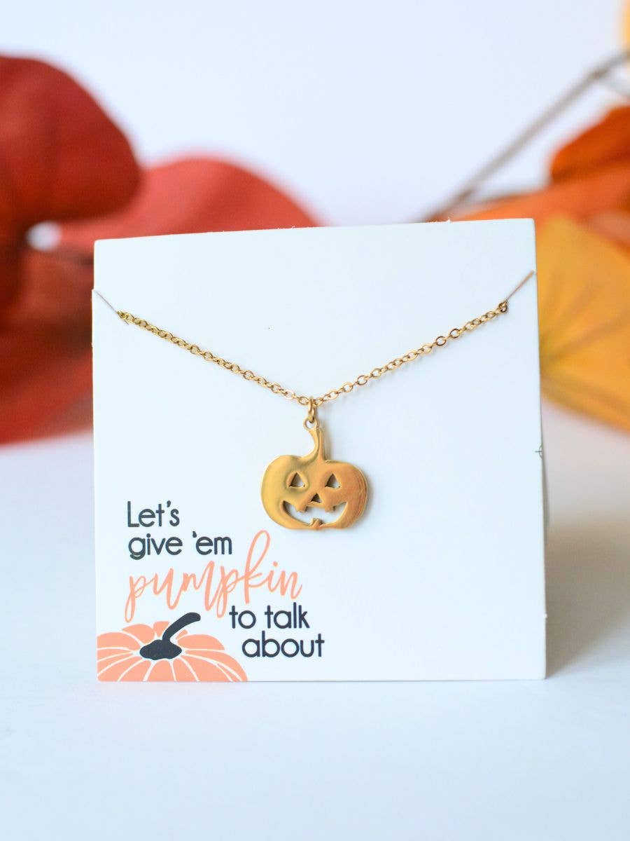 Gold Pumpkin Necklace with a jack-o-lantern pendant on a card that reads, Lets give em pumpkin to talk about.