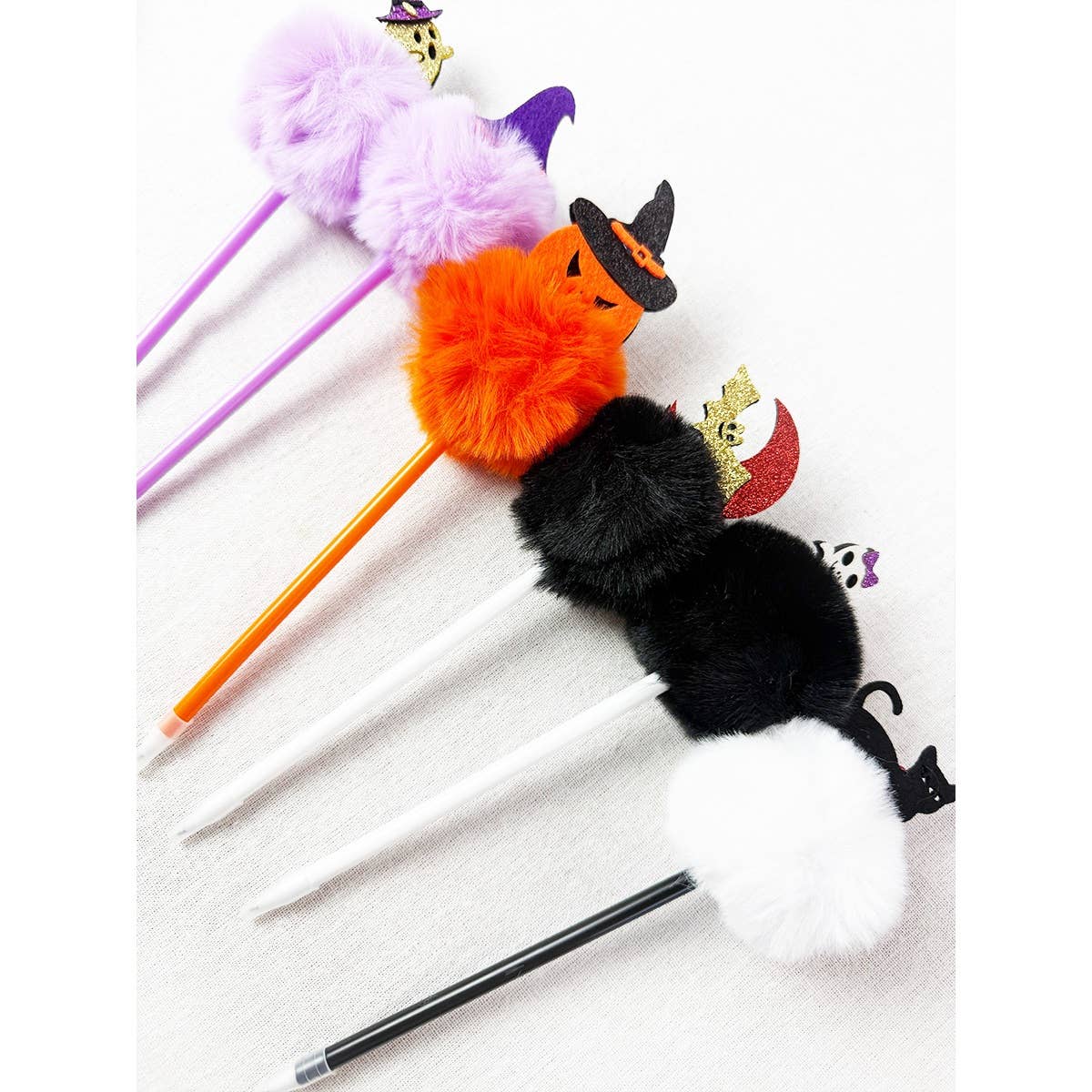 Five Halloween Theme PomPom Pen writing instruments topped with colorful pom-poms decorated with Halloween-themed icons including pumpkins, cats, witches hats, and ghosts.