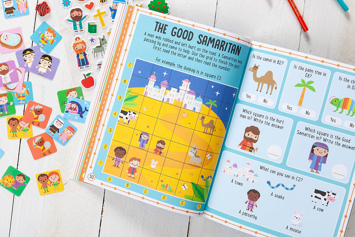 My Bible Stories Activity Book by BroadStreet Publishing Group, LLC is open to a vibrant Good Samaritan story page featuring a grid puzzle, quiz questions, and illustrated Bible characters. Sticker sheets and colored pencils rest nearby on a white wooden table.
